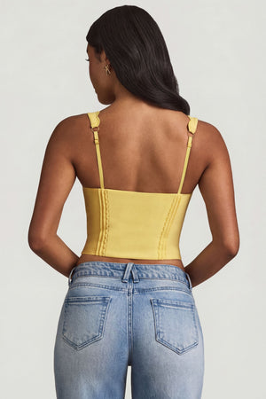Oh Polly's Yarelis wearing the Lucia Corset Top in Pastel Yellow Stretch Woven fabric perfect for summer brunches