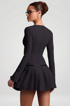 Oh Polly's Anna wearing the Fiorella Mini Dress in Black Stretch Woven fabric perfect for a night out
