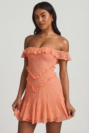 Oh Polly's Yarelis wearing the Nahida Mini Dress in Peach Stretch Lace fabric perfect for romantic date nights
