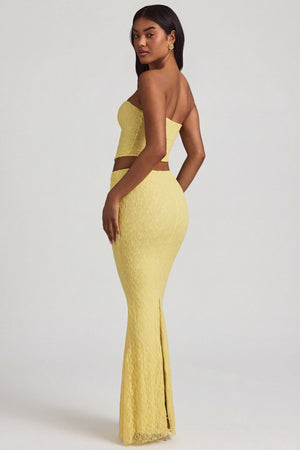 Oh Polly's Yarelis wearing the Vanda Maxi Skirt in Pastel Yellow Stretch Lace fabric perfect for vacation getaways
