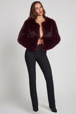 Oh Polly model Yasmin wearing the Almerinda Coat in Wine Faux Fur fabric perfect for holiday parties