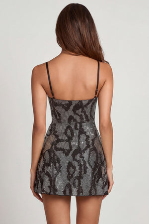 Oh Polly's Yasmin wearing the Dianora Mini Dress in Black Silver Snake Square Hotfix fabric perfect for a night out