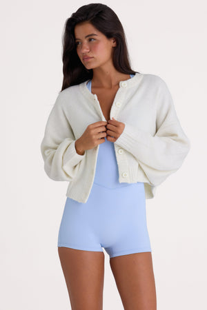 Bo+Tee model Nikki wearing the Christmas Knits Cardigan in Ivory Knitwear fabric perfect for cozy winter nights