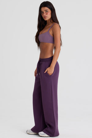 Bo+Tee model Lydia Butler wearing the CosyCoffeeRunWithLydsButler Joggers in Plum Brushback sweat fabric perfect for casual weekend strolls