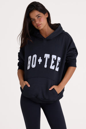 Bo+Tee model Cristal wearing the Off-Duty Hoodie in Black Cotton fabric perfect for weekend errands