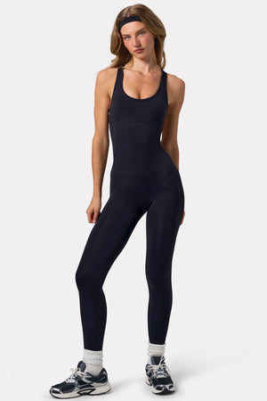 Bo+Tee model Virginia Sanhouse wearing the Silhouette Jumpsuit (reg) in Black Define Luxe (Seamless) fabric perfect for gym workouts