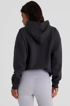Bo+Tee model Kiele wearing the Varsity Hoodie in Black Cotton fabric perfect for casual outings