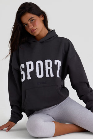 Bo+Tee model Kiele wearing the Varsity Hoodie in Black Cotton fabric perfect for weekend brunch