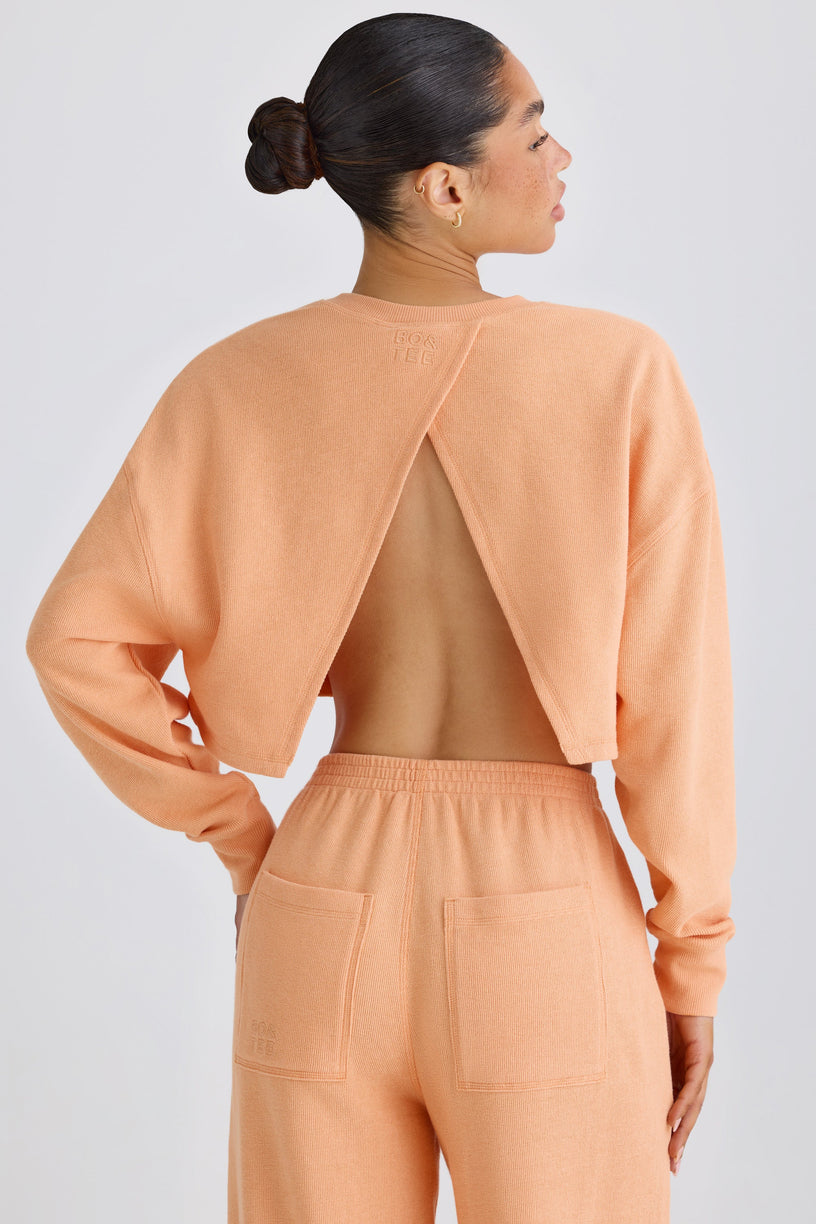 Textured Cotton Jersey Open-Back Cropped Sweatshirt in Peach - 1