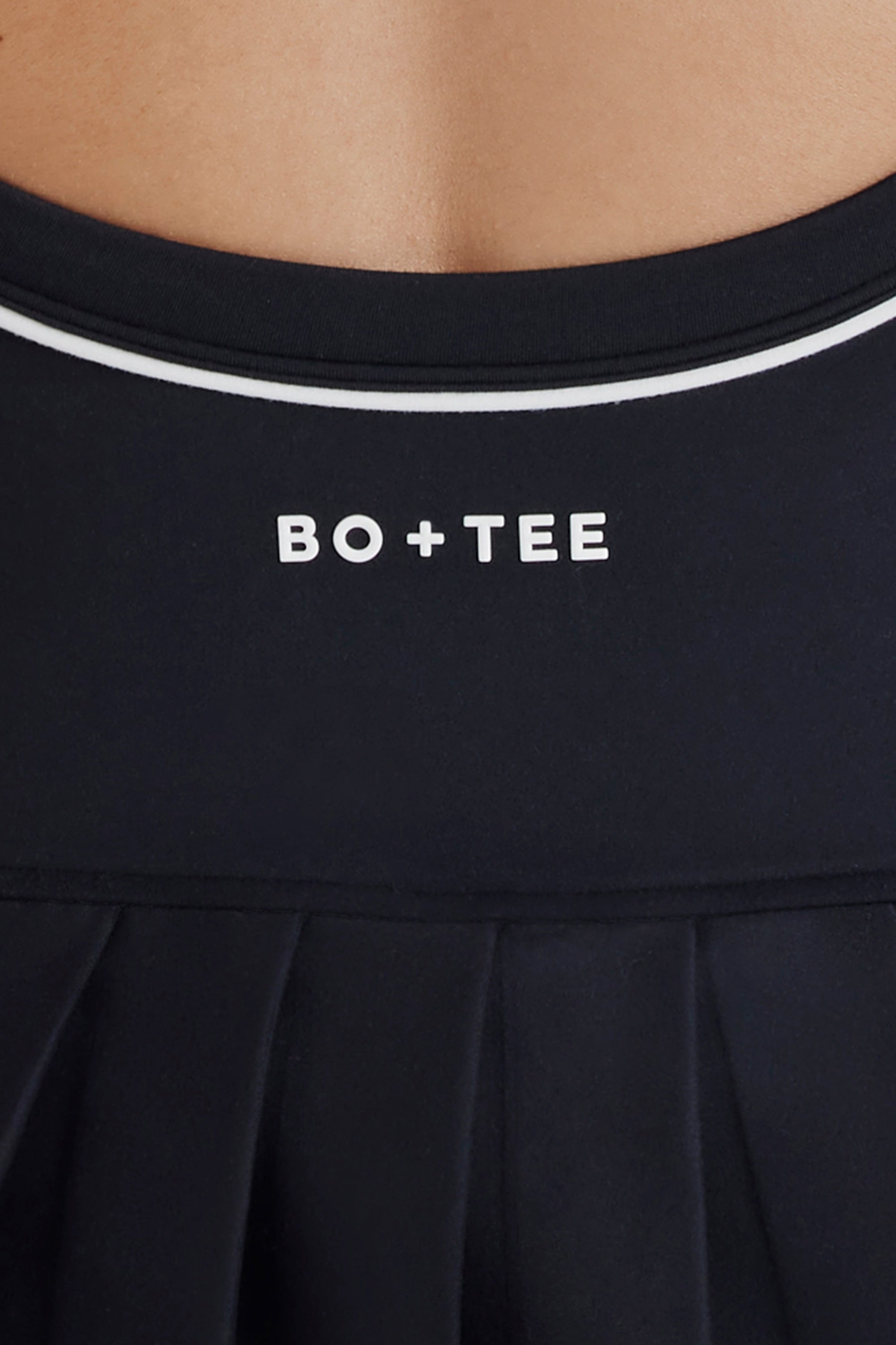Soft Active Cross-Back Pleated Tennis Dress in Black | Oh Polly