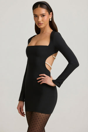 Oh Polly's Anna wearing the Akari Mini Dress in Black Satin fabric perfect for evening events