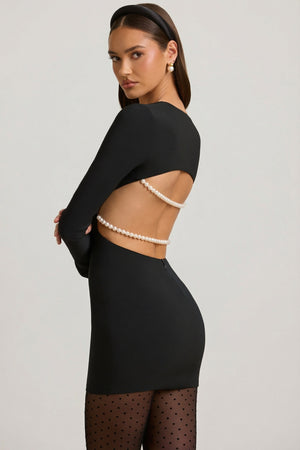 Oh Polly's Anna wearing the Akari Mini Dress in Black Satin fabric perfect for birthday dinners