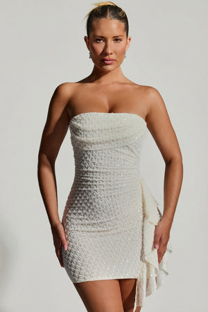 Oh Polly's Sierra Skye wearing the Ariavela Mini Dress in White Embellished fabric perfect for summer parties