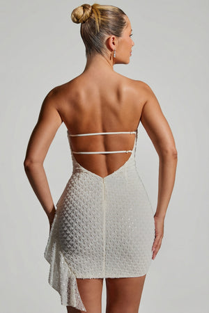 Oh Polly's Sierra Skye wearing the Ariavela Mini Dress in White Embellished fabric perfect for rooftop dinners