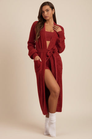 Oh Polly's Hayley wearing the Priya Cardigan in Ruby Red fabric perfect for cozy winter evenings