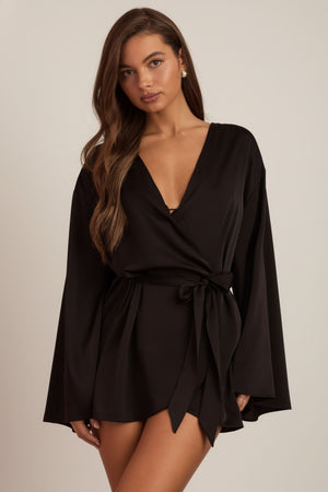 Oh Polly's Hayley wearing the Reina Cardigan in Black Satin fabric perfect for date night
