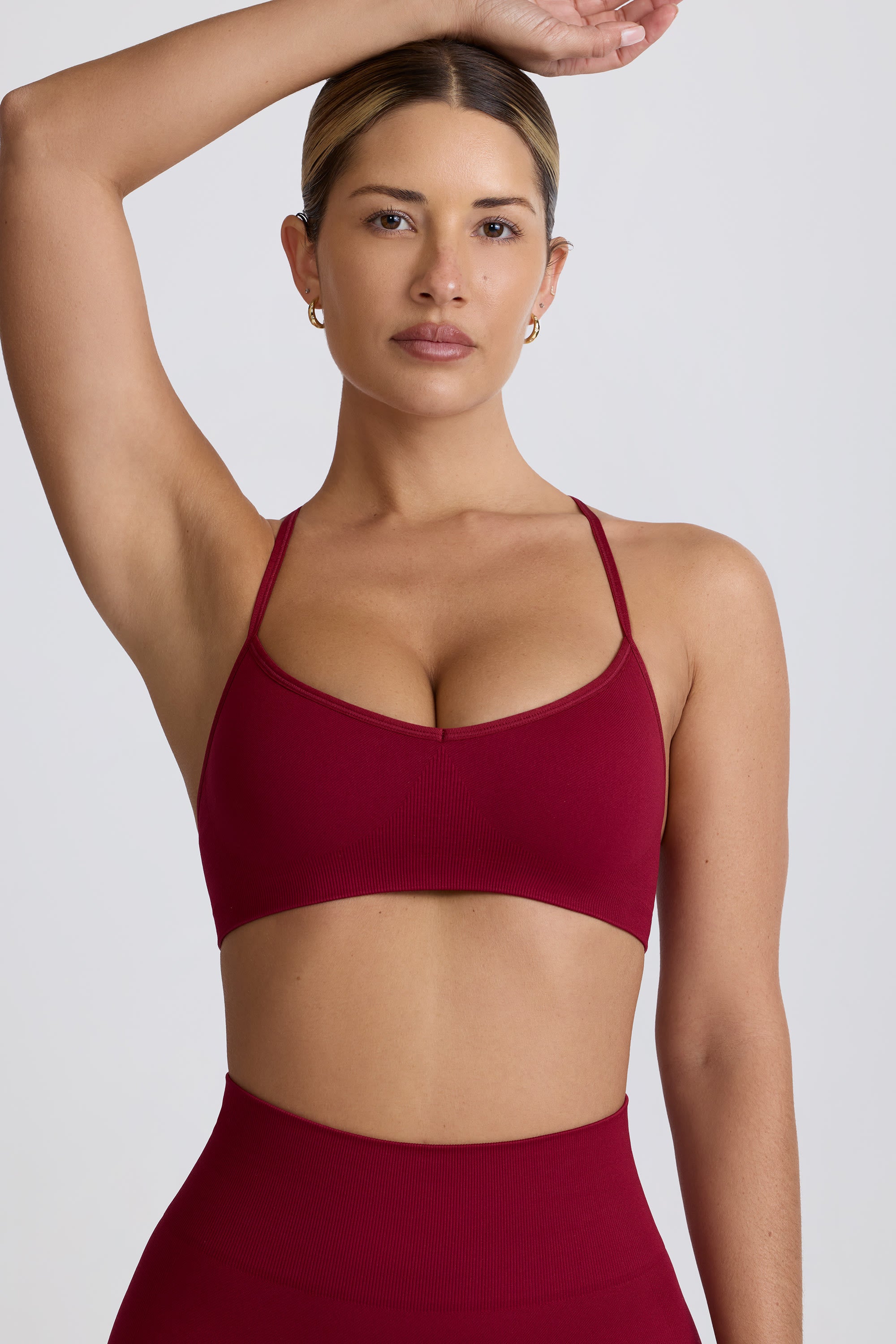 Super Sculpt Seamless Cross-Back Sports Bra in Burgundy | Oh Polly