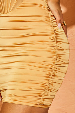 close up of ruching , mini dress in beige.