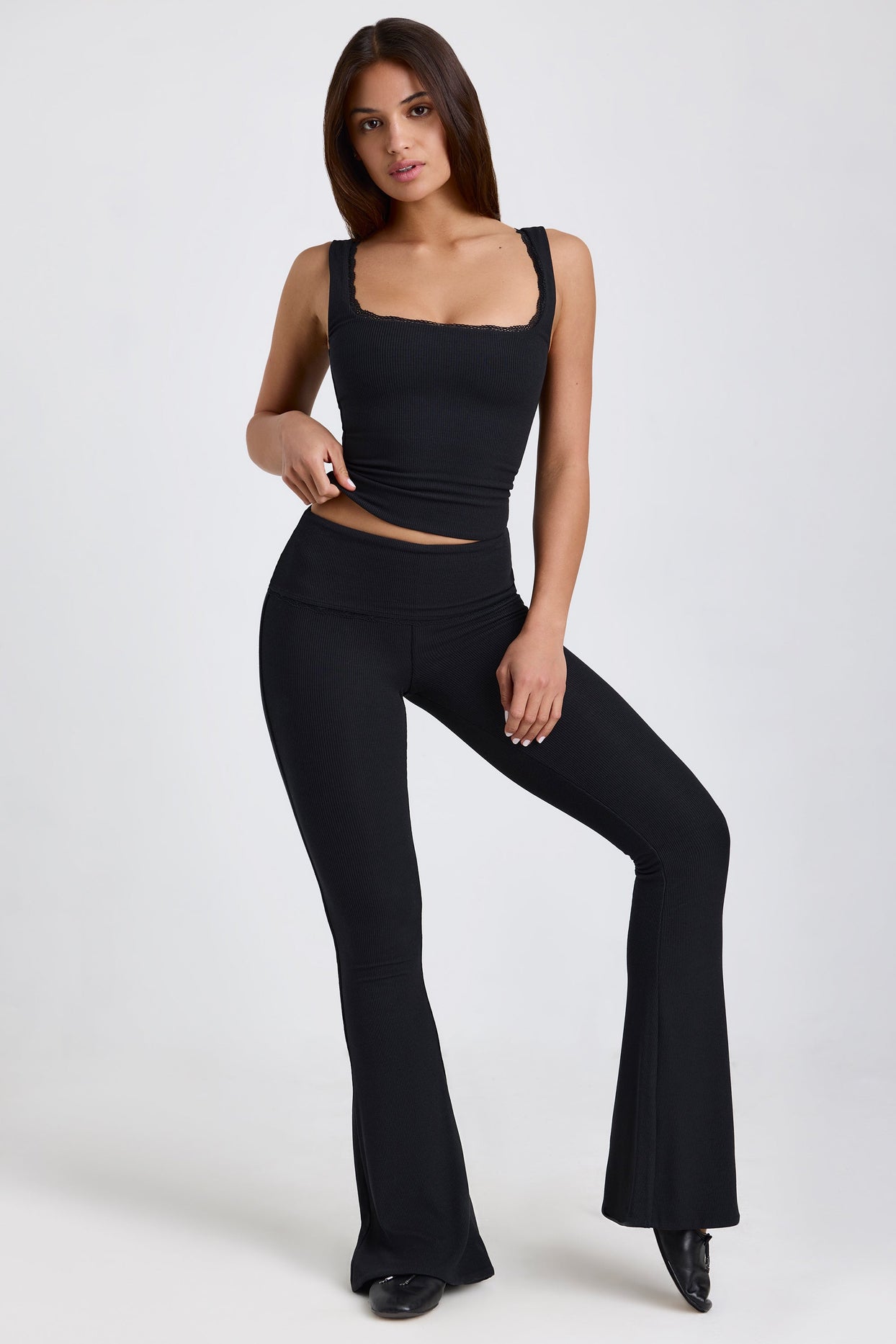 Jules Ribbed Modal Mid-Rise Foldover Flared Trousers in Black | Oh Polly