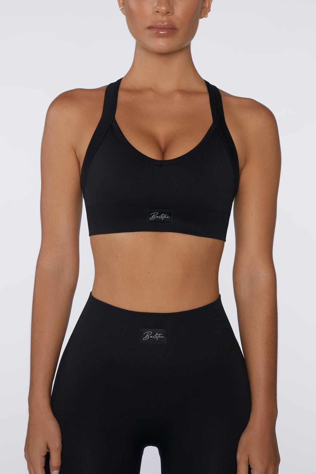 Purpose Cross Back Sports Bra in Black Oh Polly